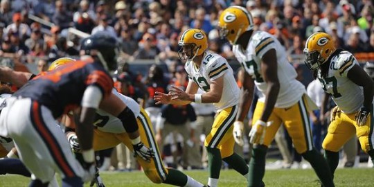 Packers Quarterback Aaron Rodgers takes a snap against the Bears